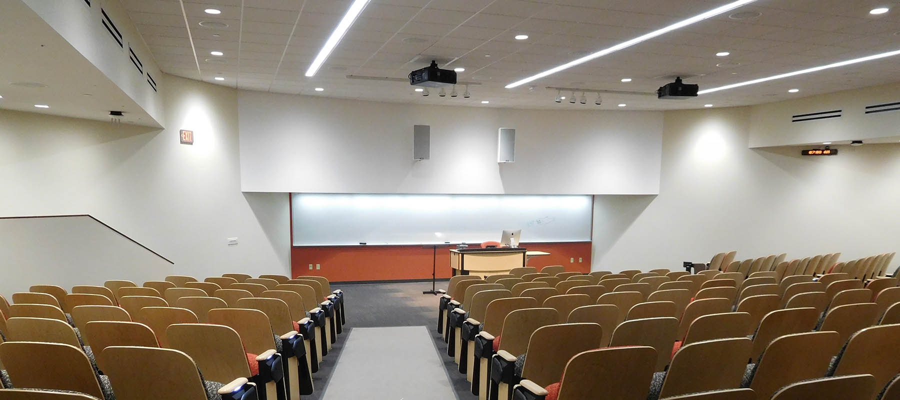 A lecture room at UW Oshkosh with recessed ceiling lights, projectors and audio system