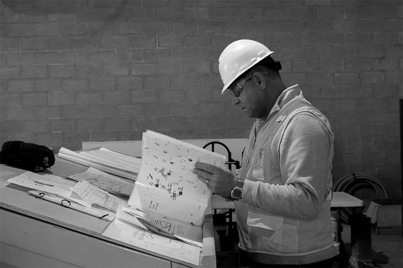 Jim Conard reviewing building plans on a job site