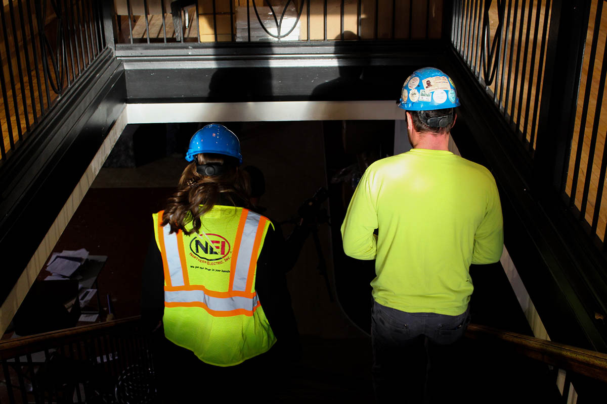 Katelyn Conard-Piontek and employee walking down stairs at the bliss job site