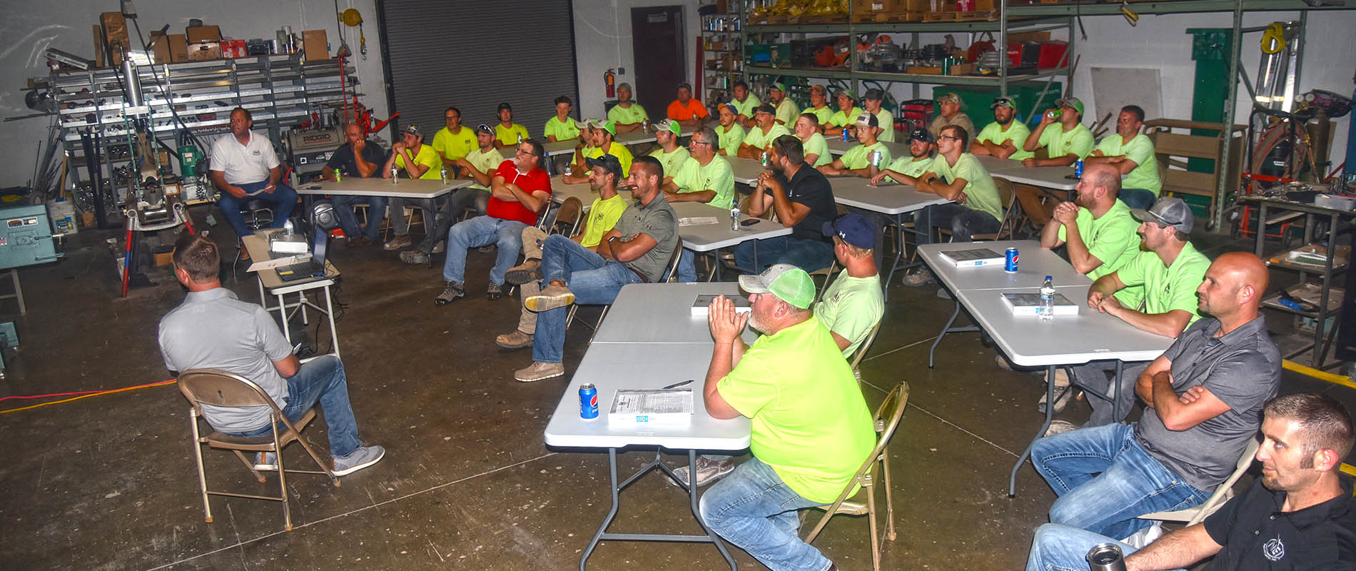 A group of NEI electricians gathered in the shop for a safety training session
