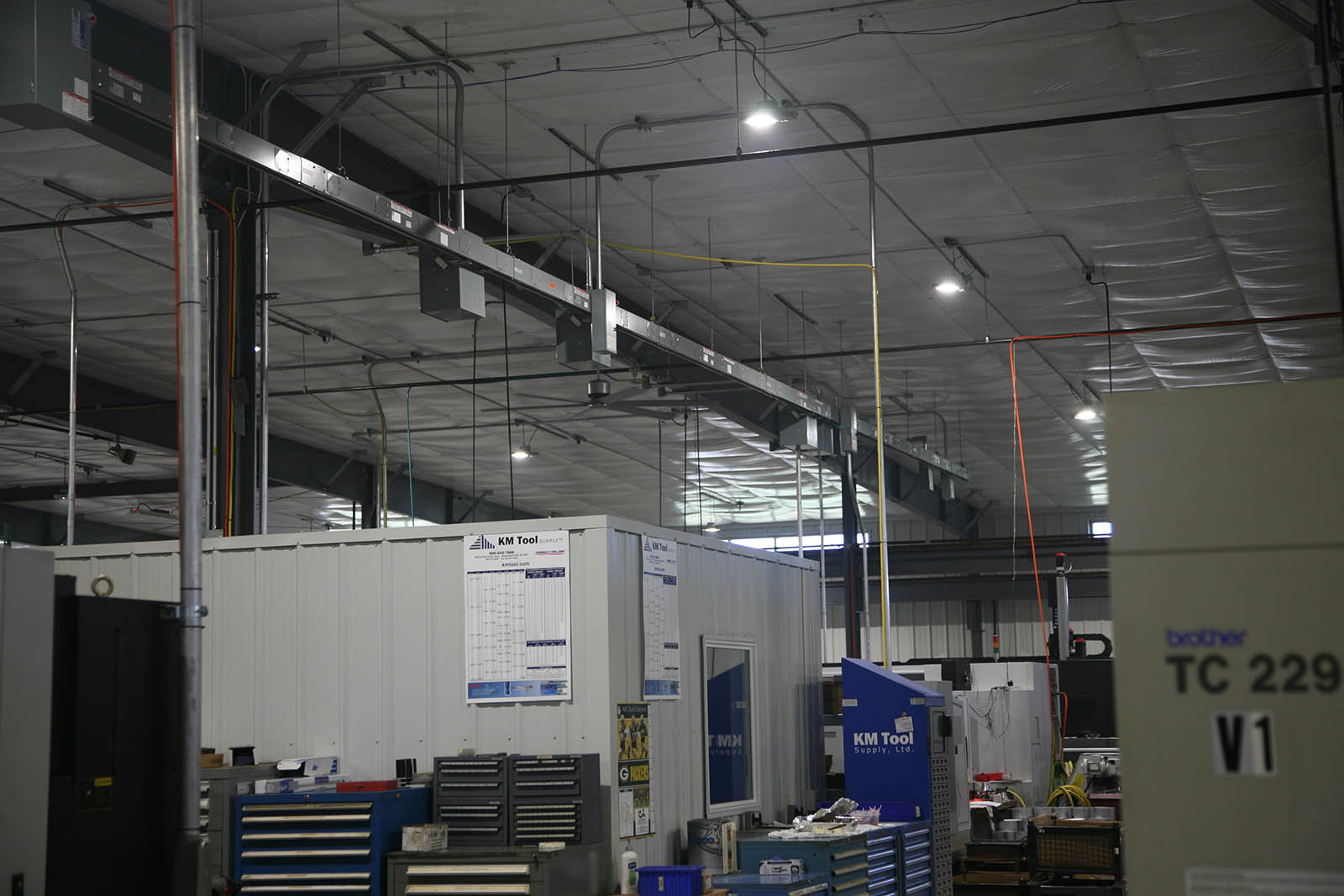 Overhead electrical conduit powering CNC Machines at Pro Products in Sturgeon Bay, WI