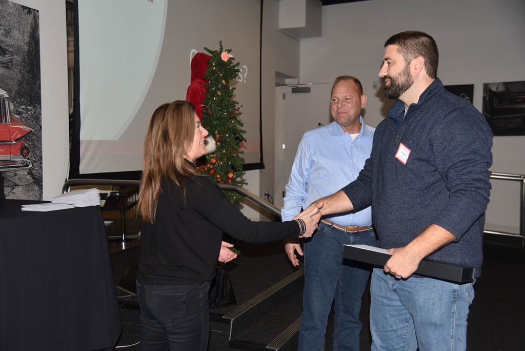 CEO Tracy Conard shaking hands with project manager Eric Hebel